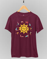 Maroon t-shirt with a yellow sun and yoga poses graphic on a gray background